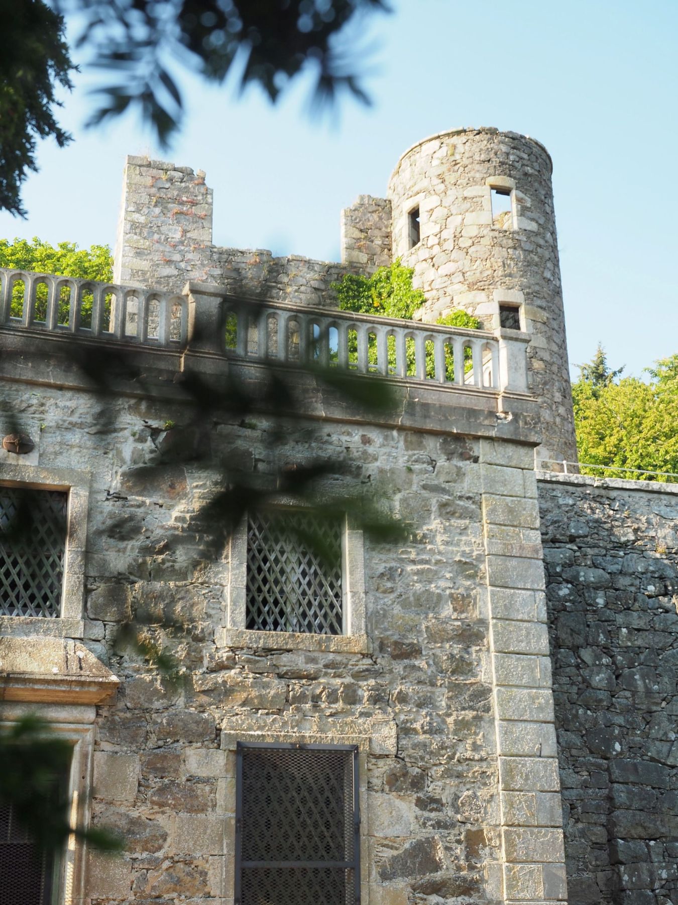 The round tower of the old castle among trees